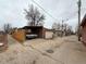 A view of the back of the property with a detached garage and an alleyway entrance, plus a classic car at 4159 Wyandot St, Denver, CO 80211