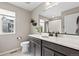 Bright bathroom with a single vanity, large mirror, toilet and window with exterior view at 138 Lullaby Ln, Castle Rock, CO 80109
