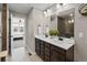 Modern bathroom with double sinks, sleek fixtures, and a view to the bedroom area at 138 Lullaby Ln, Castle Rock, CO 80109