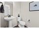 Powder room featuring a pedestal sink, modern fixtures, and neutral decor at 138 Lullaby Ln, Castle Rock, CO 80109