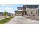 Lovely home exterior with a long driveway, well-kept lawn, and neutral-colored facade at 138 Lullaby Ln, Castle Rock, CO 80109