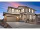 Charming two-story home featuring a two-car garage and cozy covered porch, set against a colorful evening sky at 138 Lullaby Ln, Castle Rock, CO 80109