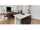 Open concept kitchen with island flows into dining and living areas, showcasing modern living at 138 Lullaby Ln, Castle Rock, CO 80109