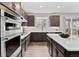 Bright kitchen boasts stainless appliances, ample cabinets, white subway tile backsplash, and island at 138 Lullaby Ln, Castle Rock, CO 80109
