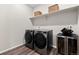 Laundry room with modern washer and dryer, storage shelves, and a beverage cooler at 138 Lullaby Ln, Castle Rock, CO 80109