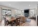 Open-concept living area with fireplace and dining table, featuring hardwood floors and plenty of natural light at 138 Lullaby Ln, Castle Rock, CO 80109