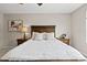 Comfortable main bedroom featuring a wooden bed frame, soft lighting, and neutral decor at 138 Lullaby Ln, Castle Rock, CO 80109