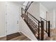 Modern staircase with sleek metal railings and wood steps, leading to upper floors with ample natural light at 138 Lullaby Ln, Castle Rock, CO 80109