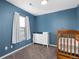 bedroom with dresser, crib, and light blue walls at 6108 Summit Peak Ct # 102, Erie, CO 80516