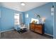 bedroom with dresser, toddler bed, and light blue walls at 6108 Summit Peak Ct # 102, Erie, CO 80516