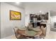 Dining area with kitchen view, a round table and four beige chairs at 6108 Summit Peak Ct # 102, Erie, CO 80516