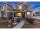 Two-story townhome with a red door and walkway at 6108 Summit Peak Ct # 102, Erie, CO 80516