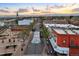 An aerial view of a colorful street in a charming town with a majestic mountain backdrop at sunset at 5402 Carr St # 307, Arvada, CO 80002
