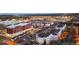 Apartment complex featuring modern architecture, well-lit parking, and landscaping at twilight at 5402 Carr St # 307, Arvada, CO 80002