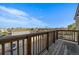 Balcony with wooden railings offers serene neighborhood views on a clear day at 5402 Carr St # 307, Arvada, CO 80002