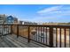 Balcony with wood decking and railings offers views of the surrounding neighborhood at 5402 Carr St # 307, Arvada, CO 80002