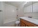 Bright bathroom with a shower and tub combination and a wood grain vanity at 5402 Carr St # 307, Arvada, CO 80002
