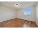 Sunny bedroom showcasing hardwood floors, a bright window, and a spacious closet at 5402 Carr St # 307, Arvada, CO 80002