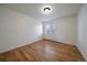 Empty bedroom showcasing wood floors, neutral walls, and a bright window at 5402 Carr St # 307, Arvada, CO 80002
