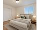 Comfortable bedroom features a neutral color palette, a cozy bed, and a bright window at 5402 Carr St # 307, Arvada, CO 80002