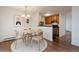 Charming dining area with a round table, seating for four, and view to the adjacent kitchen at 5402 Carr St # 307, Arvada, CO 80002