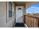Apartment 307 entry with white door, exterior window, and small, private balcony at 5402 Carr St # 307, Arvada, CO 80002