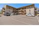 Apartment complex exterior with parking and staircases to upper units on a sunny day at 5402 Carr St # 307, Arvada, CO 80002