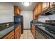Functional kitchen featuring stainless steel appliances, ample countertop space, and warm wood cabinetry at 5402 Carr St # 307, Arvada, CO 80002