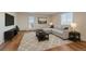 Bright living room features a comfortable sectional sofa, a modern TV console, and stylish decor at 5402 Carr St # 307, Arvada, CO 80002