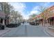 A quaint downtown street featuring sidewalk dining, beautiful trees, and a vibrant atmosphere at 5402 Carr St # 307, Arvada, CO 80002