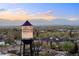 Scenic view of the historic Arvada water tower overlooking a lush landscape against a dramatic sky at 5402 Carr St # 307, Arvada, CO 80002