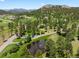 Gorgeous aerial view of a landscaped home and lot, complete with ponds and mature trees at 7197 Timbers Dr, Evergreen, CO 80439