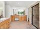 Bright, spacious bathroom with dual vanities, tile floors, and a glass-enclosed shower at 7197 Timbers Dr, Evergreen, CO 80439
