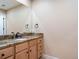 Bathroom vanity featuring granite countertops, wood cabinetry, and a large mirror at 7197 Timbers Dr, Evergreen, CO 80439