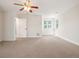 Spacious bedroom with plush carpet, ceiling fan and bright windows at 7197 Timbers Dr, Evergreen, CO 80439