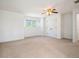 Spacious bedroom with plush carpet, ceiling fan and bright windows at 7197 Timbers Dr, Evergreen, CO 80439