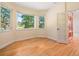 Bedroom with hardwood floors and a large window at 7197 Timbers Dr, Evergreen, CO 80439