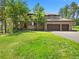 Beautiful home featuring a three-car garage and a well-manicured lawn at 7197 Timbers Dr, Evergreen, CO 80439