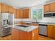 Kitchen island with granite countertop, stainless appliances and eat in breakfast bar at 7197 Timbers Dr, Evergreen, CO 80439