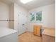 Well-lit laundry room featuring a washer, dryer, storage cabinets, and a countertop workspace at 7197 Timbers Dr, Evergreen, CO 80439