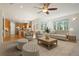 Well lit living room connected to kitchen features a large window and comfortable seating at 7197 Timbers Dr, Evergreen, CO 80439