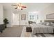 Large main bedroom with neutral tones, an upholstered bench, and an ensuite bath at 7197 Timbers Dr, Evergreen, CO 80439