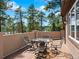 Relax on this covered deck with wrought iron table and chairs, perfect for entertaining and enjoying outdoor living at 7197 Timbers Dr, Evergreen, CO 80439