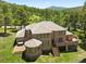 Expansive home with multiple decks, manicured lawn, and lush greenery, creating a private retreat at 7197 Timbers Dr, Evergreen, CO 80439