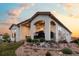 Elegant stucco home featuring a covered patio and professionally landscaped backyard at 15156 W Baker Pl, Lakewood, CO 80228