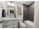 Modern bathroom featuring stylish vanity, artistic wall decor, and sleek shower and tub at 15156 W Baker Pl, Lakewood, CO 80228