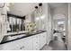 Stylish bathroom with a double vanity, modern lighting, and a view into the glass enclosed shower at 15156 W Baker Pl, Lakewood, CO 80228