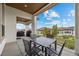 Covered patio with a table and seating, offering an outdoor space for relaxation and entertainment at 15156 W Baker Pl, Lakewood, CO 80228