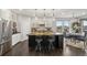 Bright and spacious kitchen featuring a center island with seating, stainless appliances, and a view into the dining area at 15156 W Baker Pl, Lakewood, CO 80228