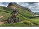 Mountain biker speeding downhill on a beautiful trail at 15156 W Baker Pl, Lakewood, CO 80228